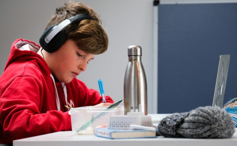 child studying afterschool while wearing headphones