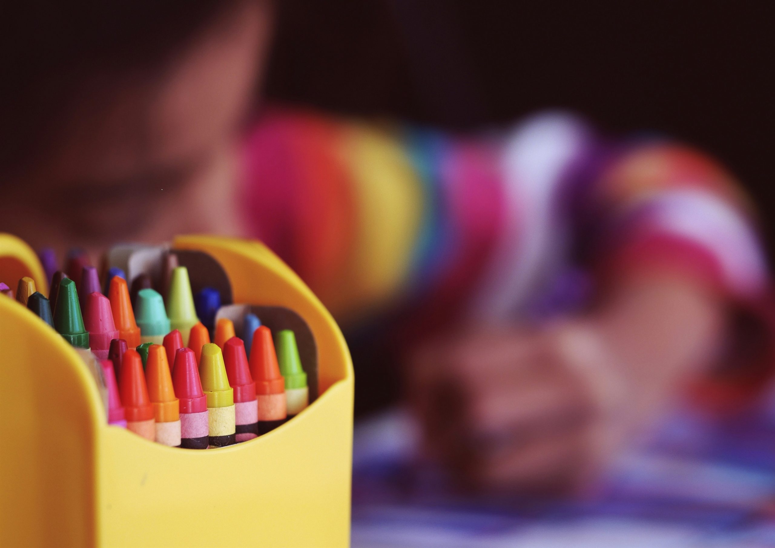 back to school image of crayons and child colouring
